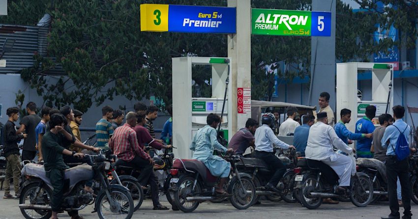 Bikers line up to outside a petrol station to receive cheap petrol under the subsidy